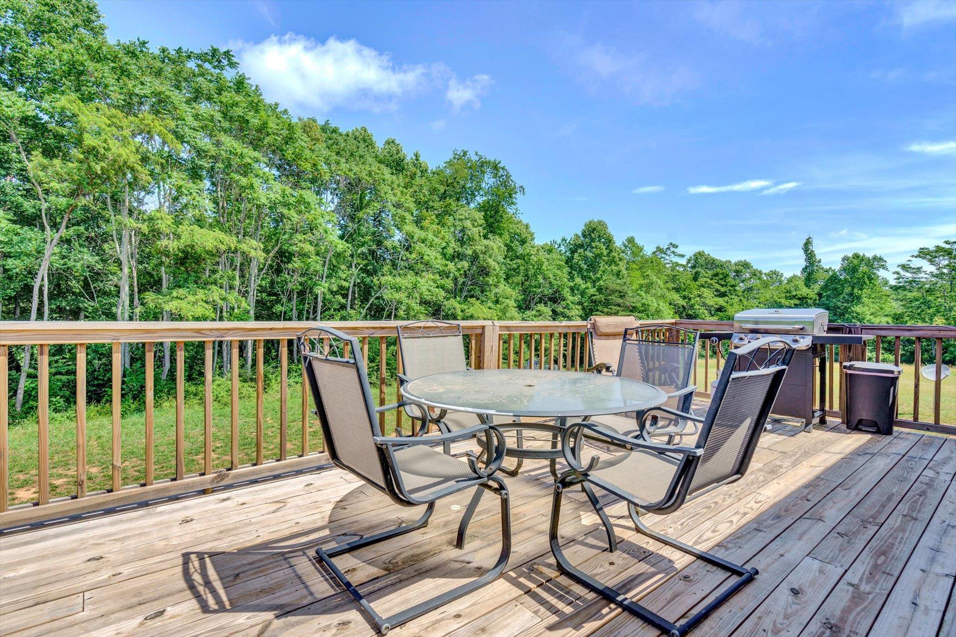 3294 Ayers Road Moneta, VA 24121 - Photo 22 of 41 a view of a chairs and table on the wooden deck