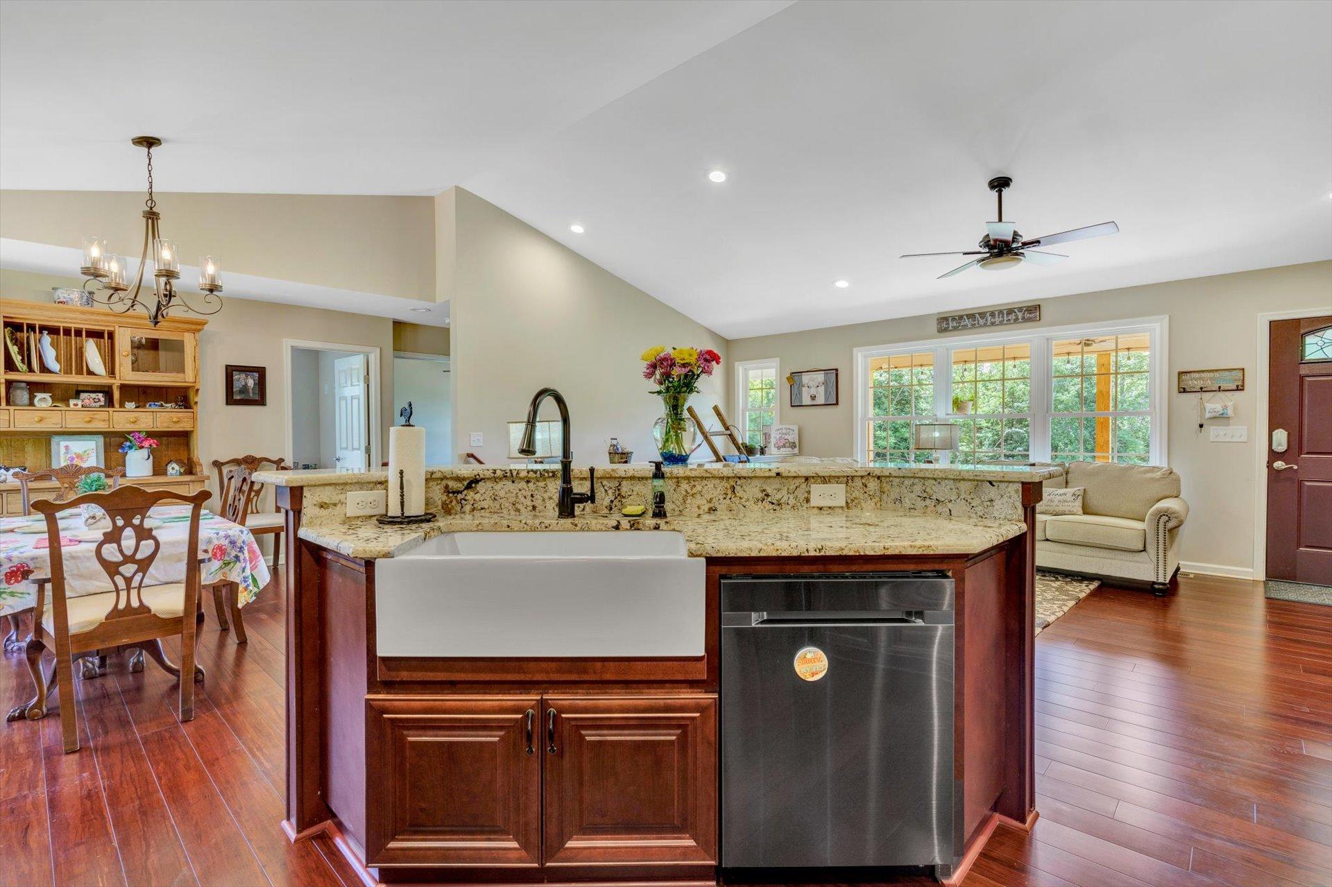 3294 Ayers Road Moneta, VA 24121 - Photo 8 of 41 a kitchen with a stove a refrigerator and a dining table with wooden floor