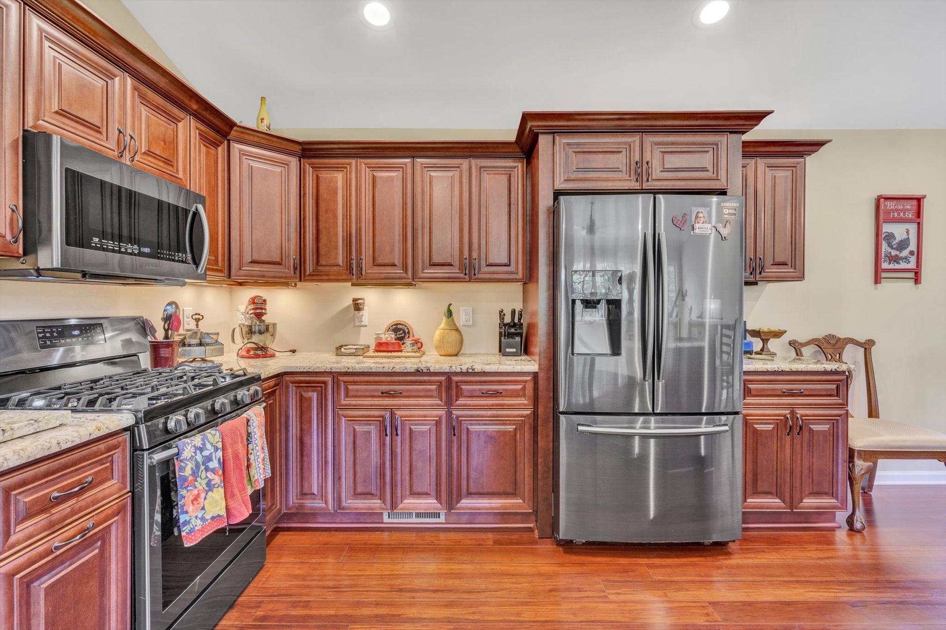 3294 Ayers Road Moneta, VA 24121 - Photo 9 of 41 a kitchen with stainless steel appliances granite countertop a refrigerator stove and wooden cabinets