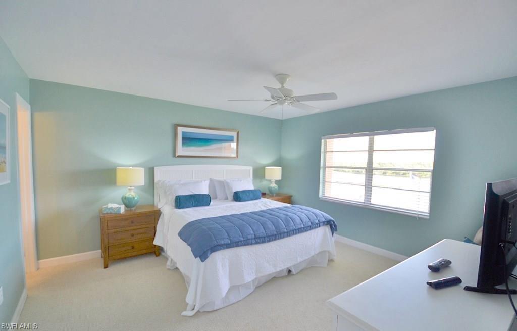 307 Goodlette-Frank Road, Unit 506B Naples, FL 34102 - Photo 12 of 25 a bedroom with a bed and a window