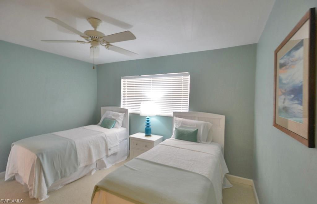 307 Goodlette-Frank Road, Unit 506B Naples, FL 34102 - Photo 15 of 25 a bedroom with two beds and a window