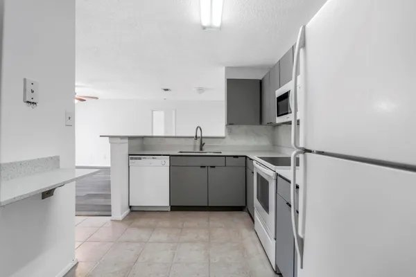 a kitchen with a sink stove and cabinets