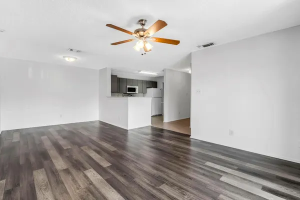 a view of a kitchen with a dishwasher and wooden floor