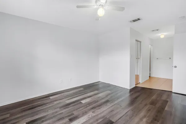 a view of a room with wooden floor and white walls