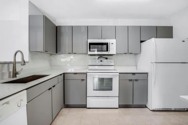 a kitchen with cabinets stainless steel appliances and sink