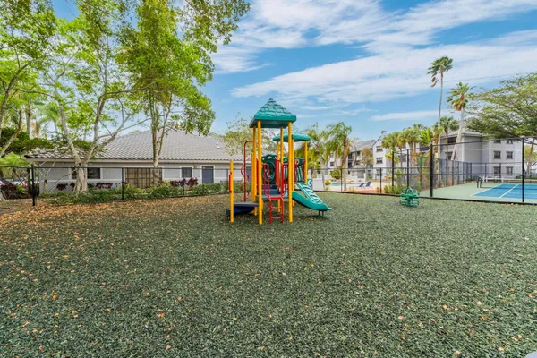 a view of outdoor space with playground and green space