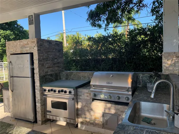 a view of a kitchen with a sink and a stove
