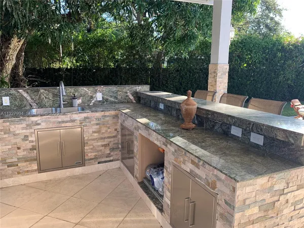a kitchen with a table chairs and a refrigerator