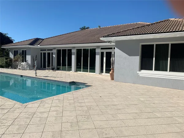 a view of a house with swimming pool and porch