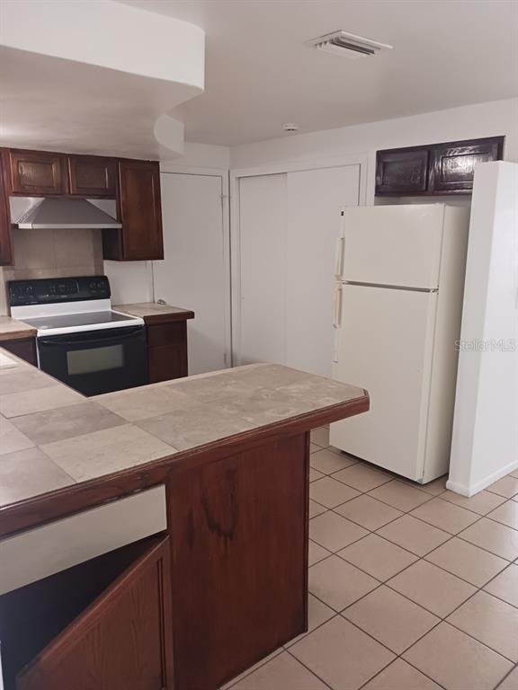 3432 Thorny Ridge Drive Holiday, FL 34691 - Photo 6 of 12 a kitchen with a refrigerator and a sink