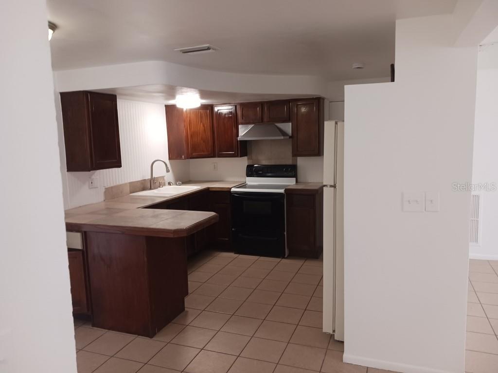 3432 Thorny Ridge Drive Holiday, FL 34691 - Photo 8 of 12 a kitchen with a sink and a refrigerator