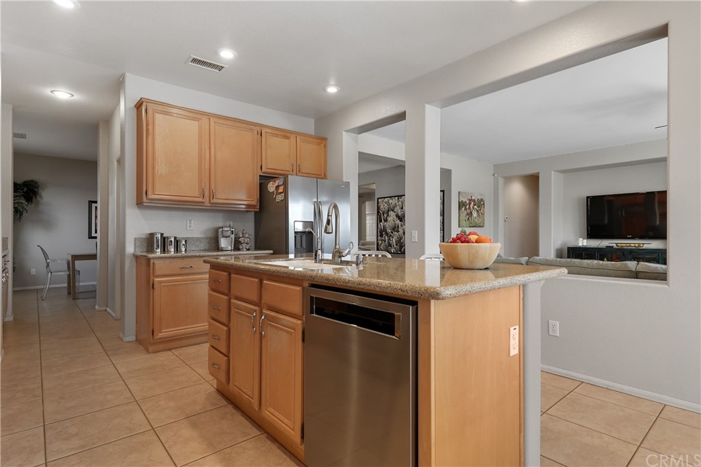 82551 Grant Drive Indio, CA 92201 - Photo 11 of 45 a kitchen with stainless steel appliances granite countertop a sink and cabinets