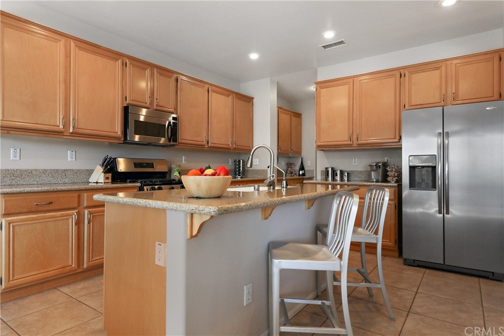 82551 Grant Drive Indio, CA 92201 - Photo 14 of 45 a kitchen with stainless steel appliances granite countertop a refrigerator sink and cabinets