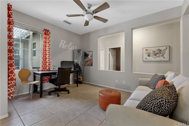 a living room with stainless steel appliances kitchen island a table and chairs in it