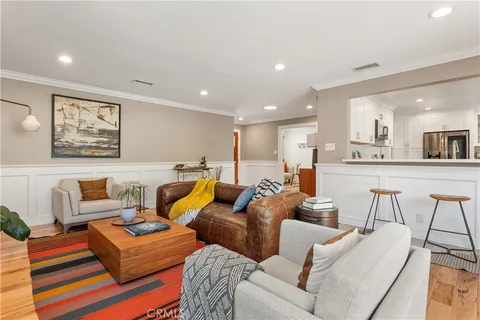 a living room with furniture and kitchen view