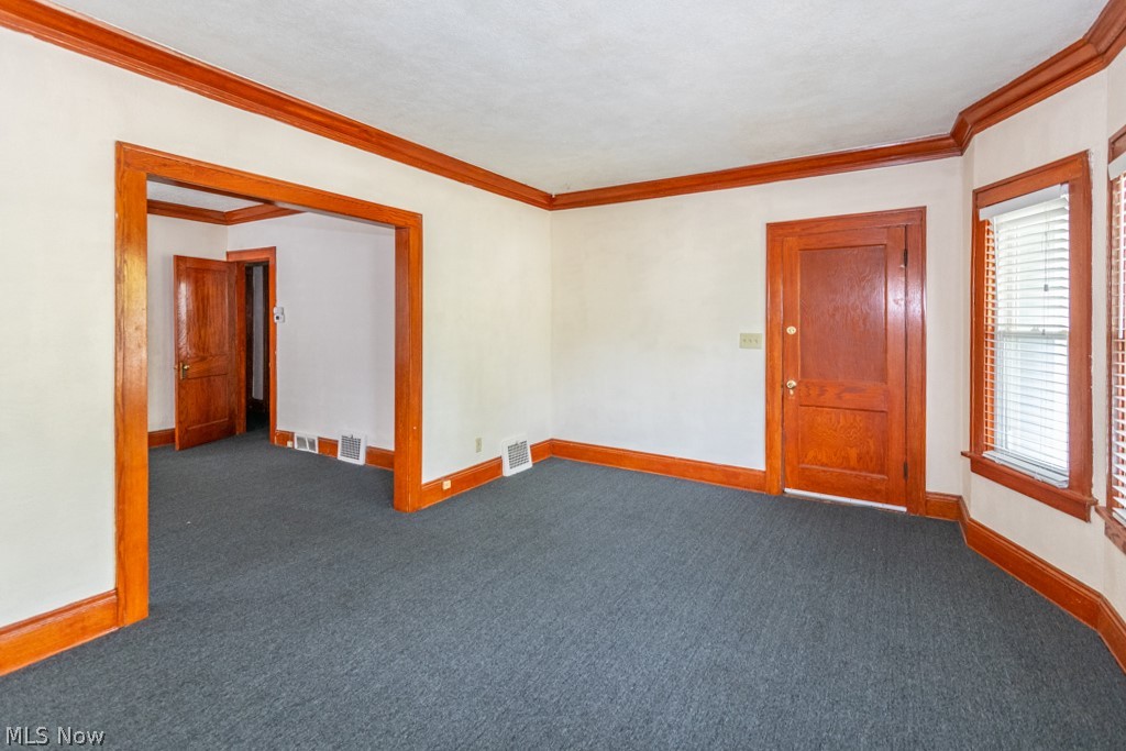 917 Helmsdale Road Cleveland Heights, OH 44112 - Photo 9 of 28 Carpeted empty room featuring baseboards and crown molding