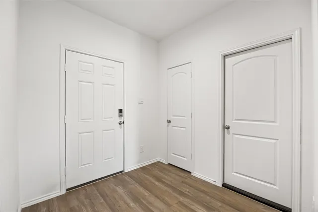 an empty room with wooden floor