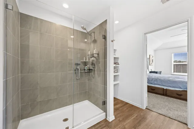 a bathroom with a shower and a sink