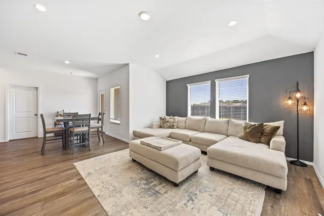 a living room with furniture and wooden floor