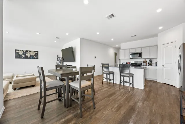 a view of a dining room with furniture and wooden floor
