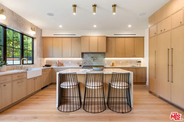 a kitchen with a sink window and cabinets
