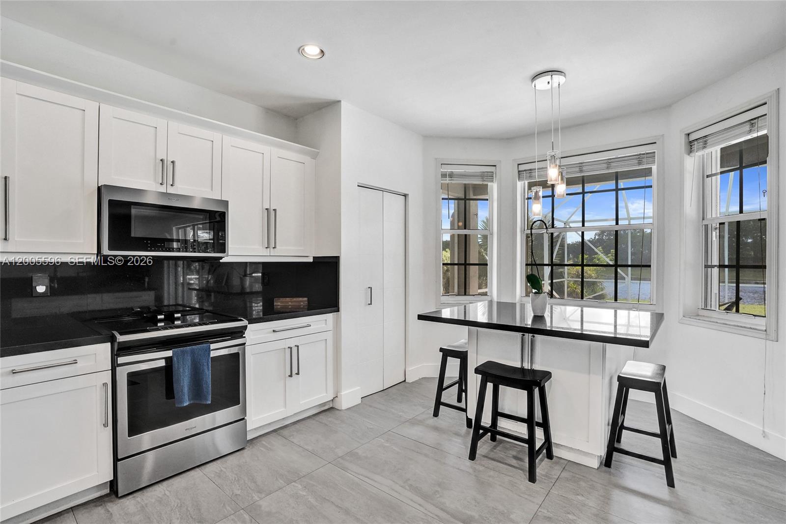 4281 Laurel Ridge Circle Weston, FL 33331 - Photo 28 of 80 a kitchen with stainless steel appliances granite countertop a stove a sink dishwasher a refrigerator and a microwave oven with wooden floor