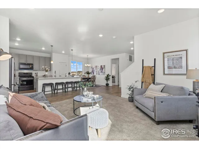 a living room with furniture and kitchen view
