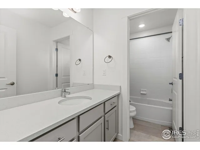 a bathroom with a sink shower and a mirror