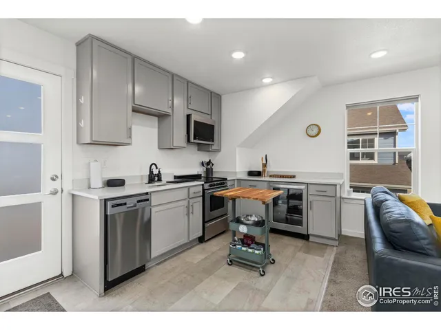 a kitchen with a sink appliances and cabinets