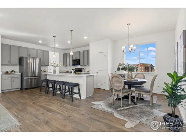 a view of kitchen with dining room and wooden floor