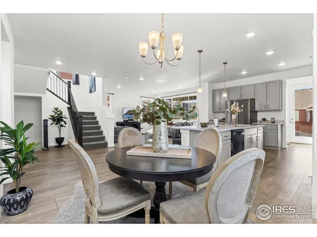 a dining room with furniture and wooden floor