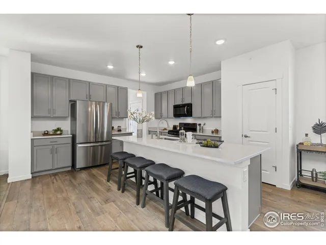 a kitchen with refrigerator cabinets and wooden floor