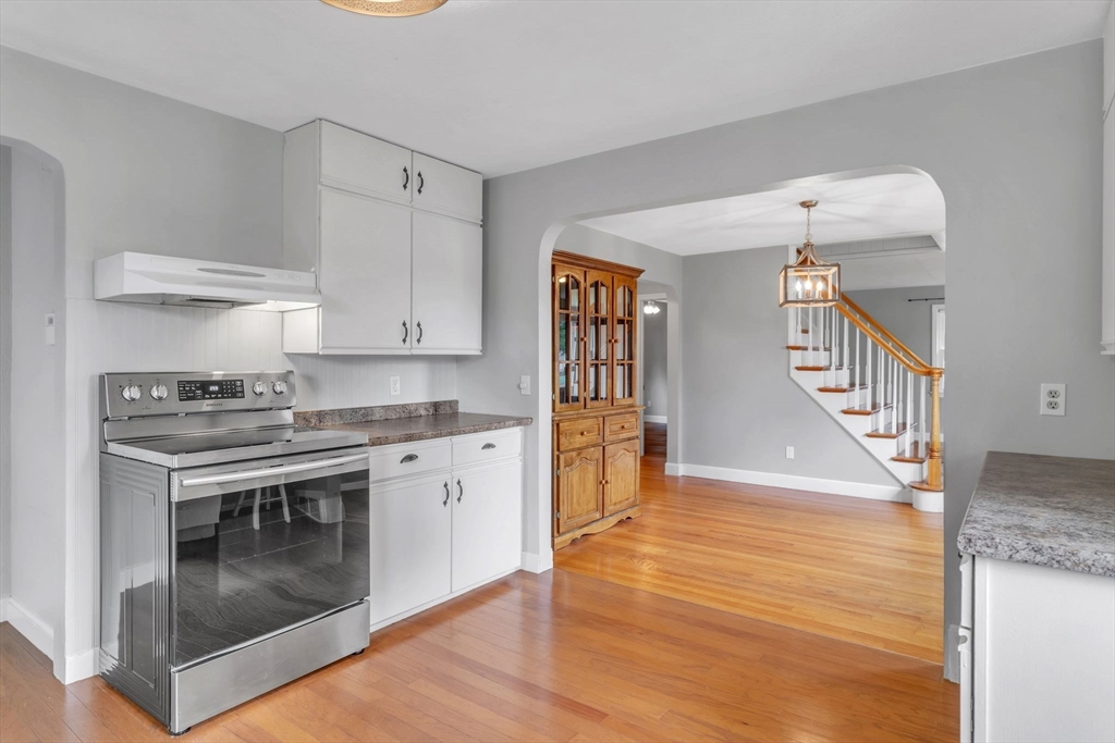 97 Old Brook Road Springfield, MA 01118 - Photo 11 of 42 a kitchen with granite countertop a stove and a wooden floors