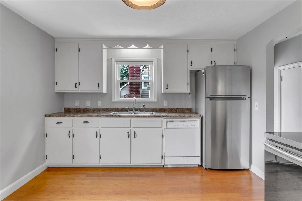 97 Old Brook Road Springfield, MA 01118 - Photo 12 of 42 a kitchen with granite countertop white cabinets and refrigerator