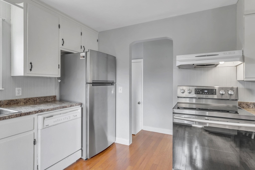 97 Old Brook Road Springfield, MA 01118 - Photo 13 of 42 a kitchen with stainless steel appliances white cabinets and a refrigerator