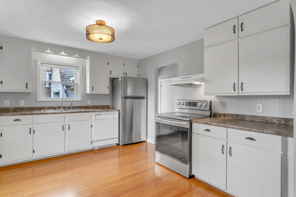 97 Old Brook Road Springfield, MA 01118 - Photo 14 of 42 a kitchen with granite countertop white cabinets and stainless steel appliances