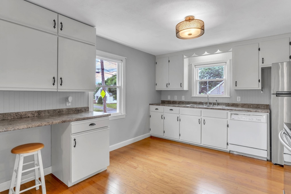 97 Old Brook Road Springfield, MA 01118 - Photo 15 of 42 a kitchen with granite countertop white cabinets and window
