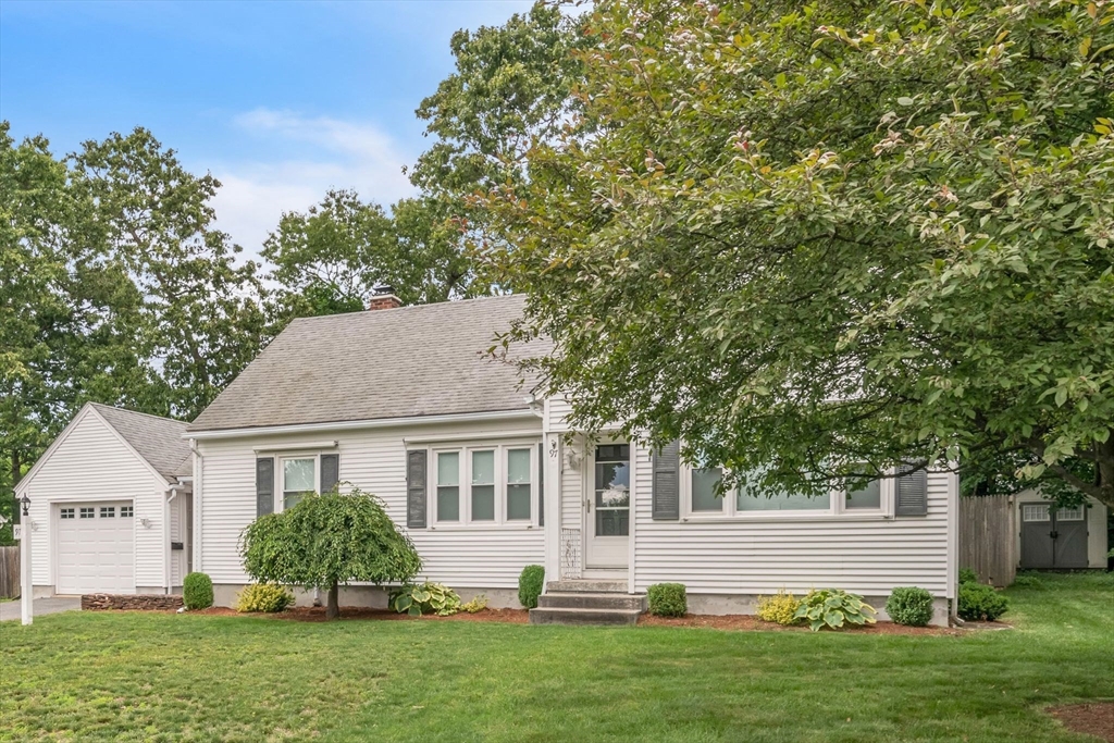 97 Old Brook Road Springfield, MA 01118 - Photo 2 of 42 a front view of a house with a garden and yard