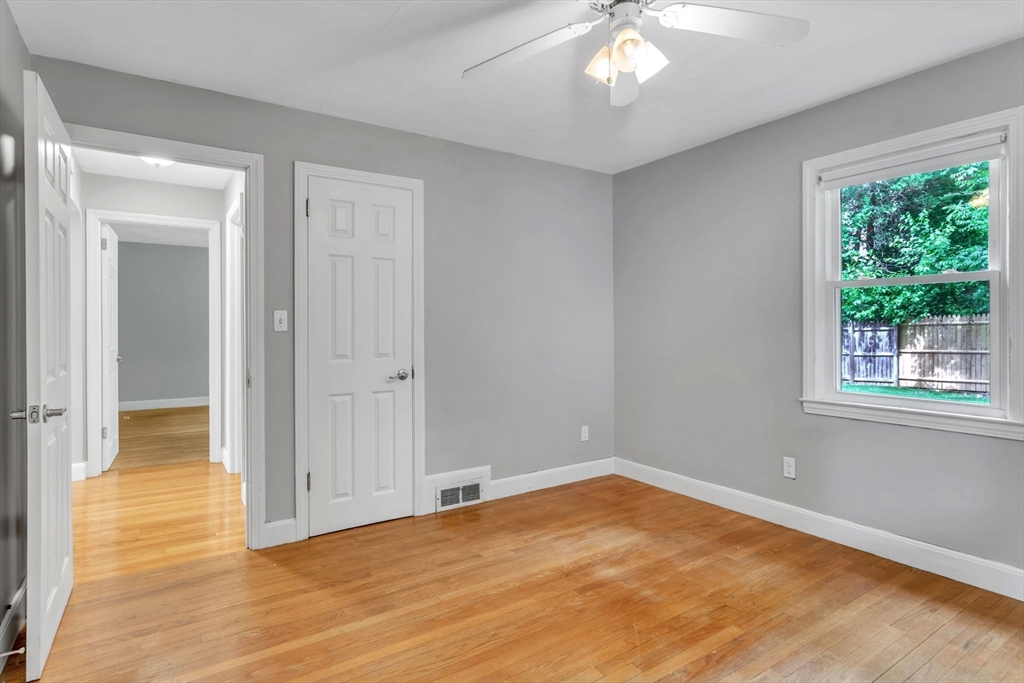 97 Old Brook Road Springfield, MA 01118 - Photo 21 of 42 a view of an empty room with wooden floor and a window