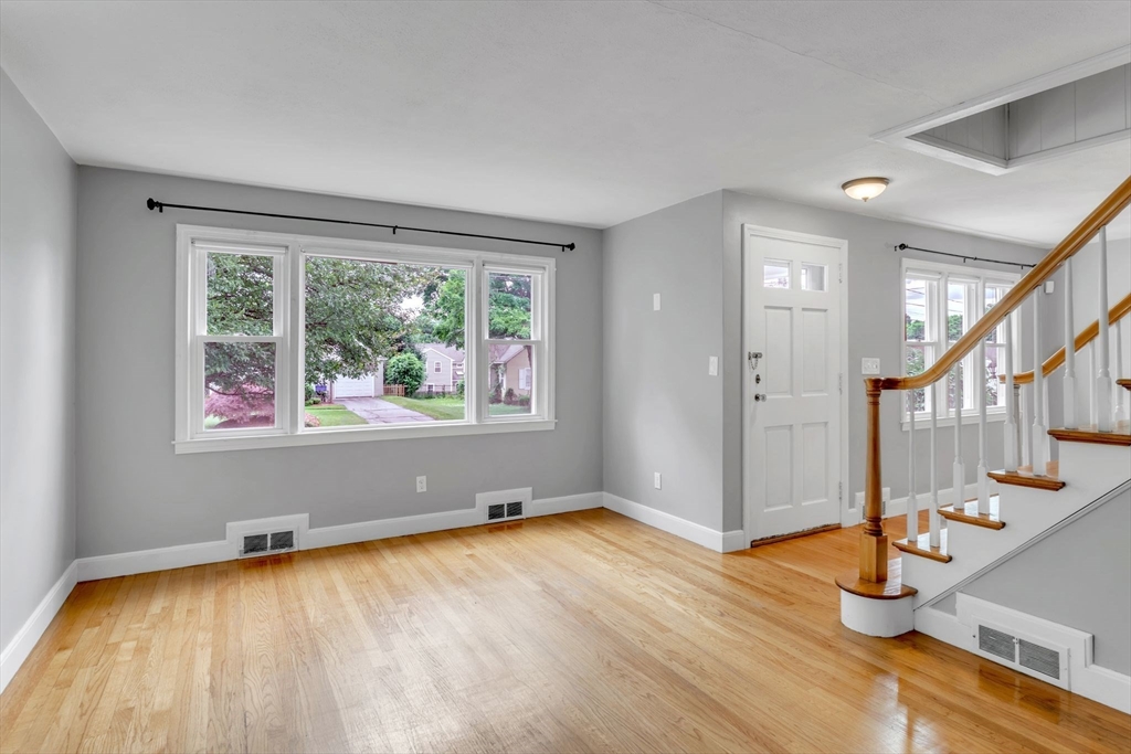 97 Old Brook Road Springfield, MA 01118 - Photo 3 of 42 a view of an empty room with wooden floor and a window