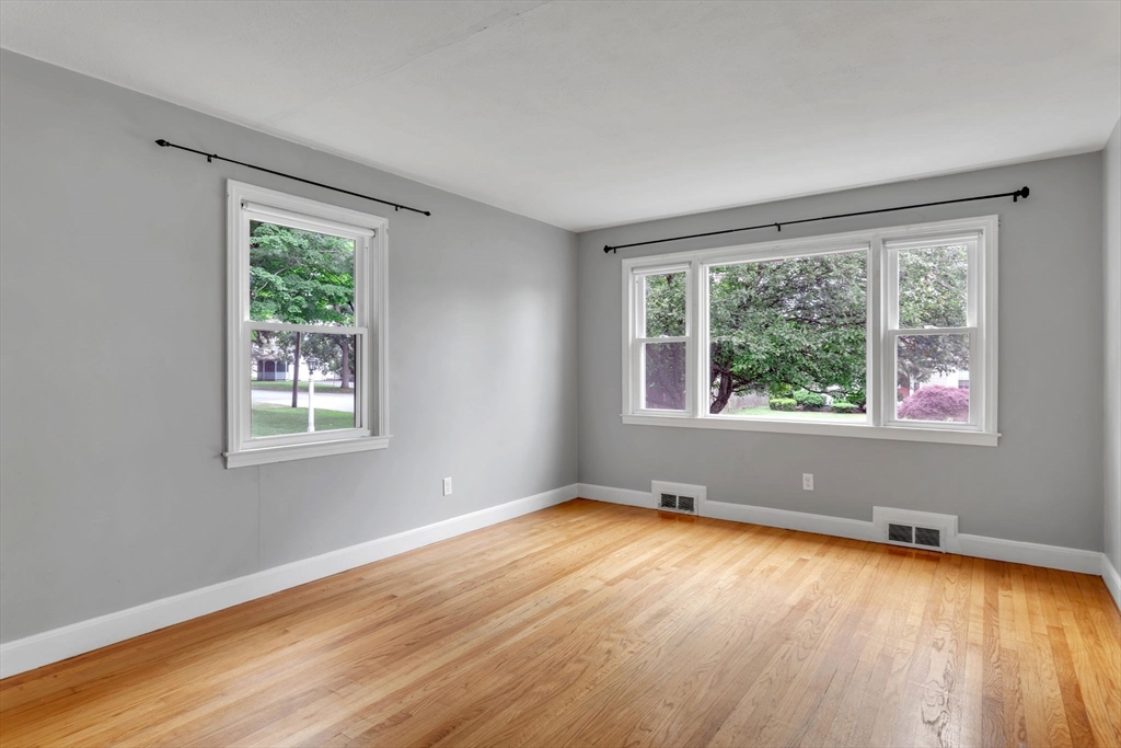 97 Old Brook Road Springfield, MA 01118 - Photo 5 of 42 a view of an empty room with wooden floor and a window