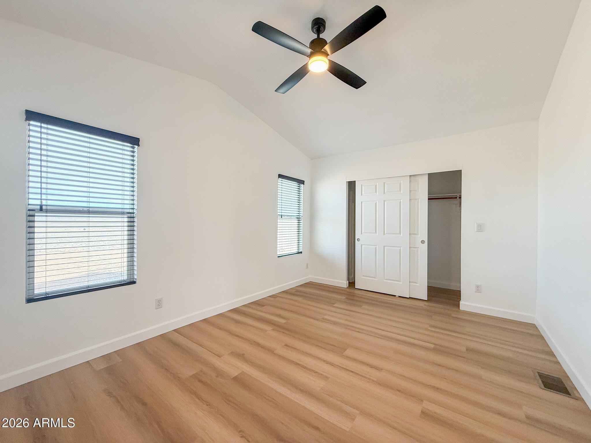 51880 North Gold Plains Road Seligman, AZ 86337 - Photo 21 of 24 a view of empty room with wooden floor and fan