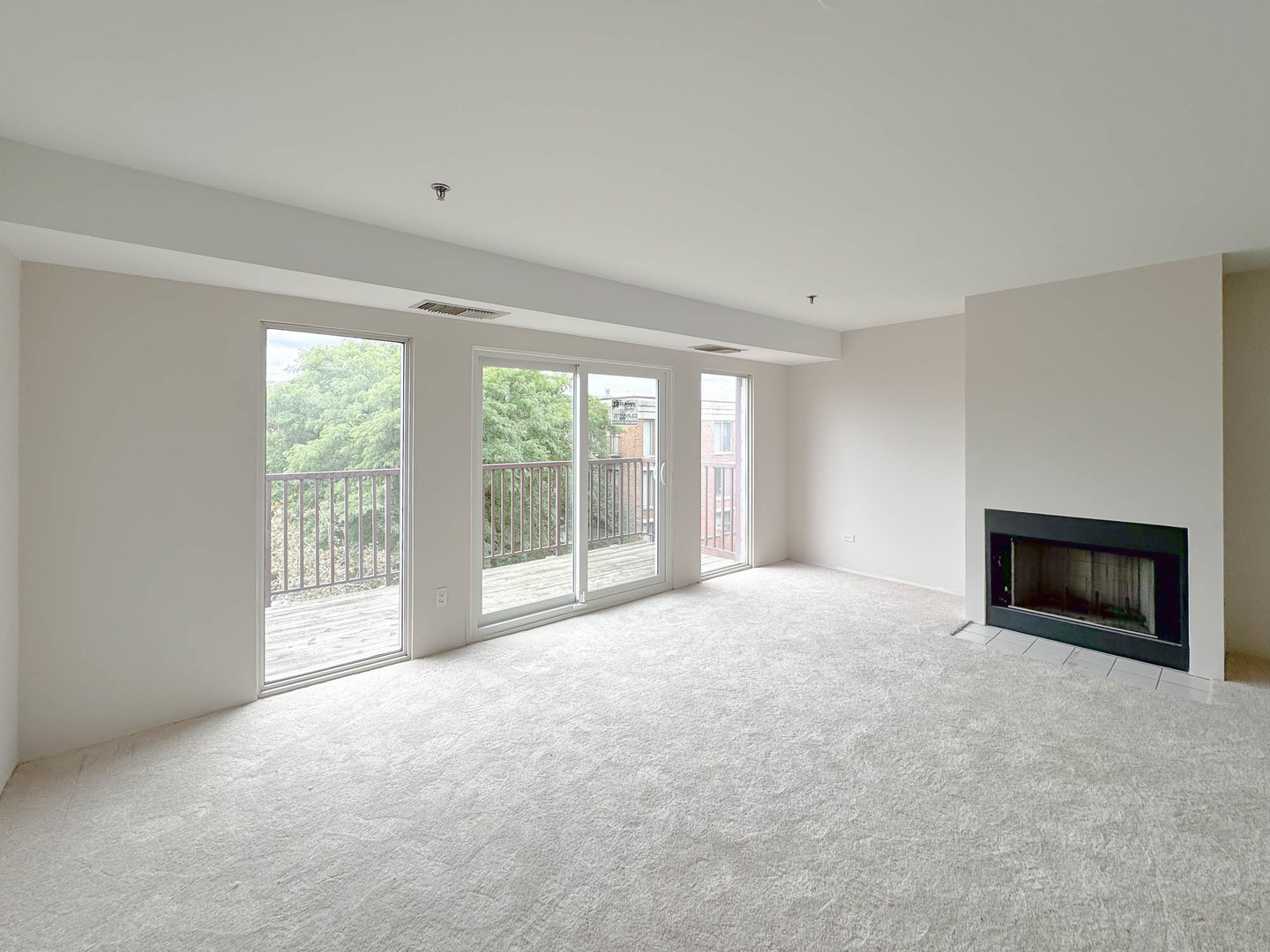 352 Kelburn Road, Unit 326 Deerfield, IL 60015 - Photo 3 of 8 a view of an empty room with a fireplace and a window