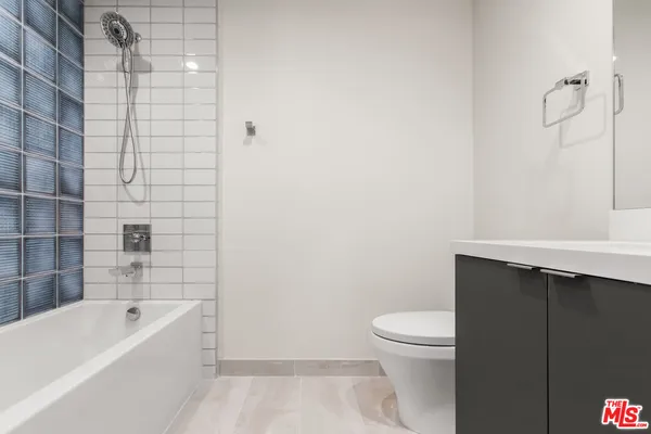 a bathroom with a bathtub and a toilet