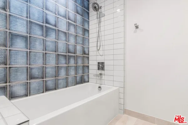 a bathroom with a bathtub and shower