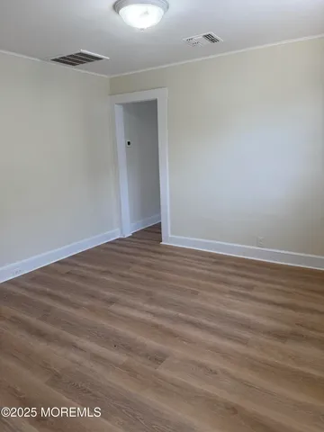 a view of room with wooden floor