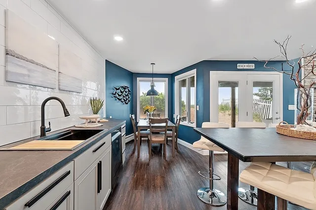 a kitchen with sink refrigerator and stove