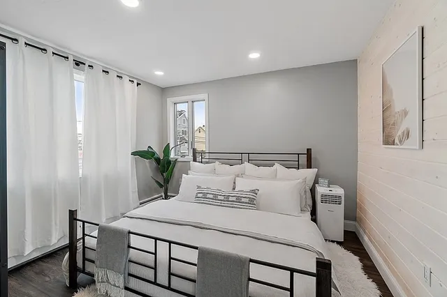 a spacious bedroom with a bed and a table in it