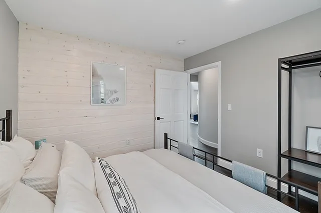 a bedroom with a bed and a mirror