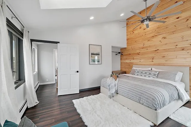 a bedroom with a bed and wooden floor